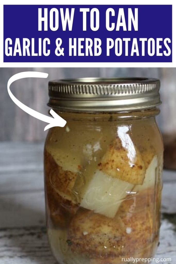 homemade canned potatoes in a mason jar on a white wood background with text that says how to can garlic and herb potatoes